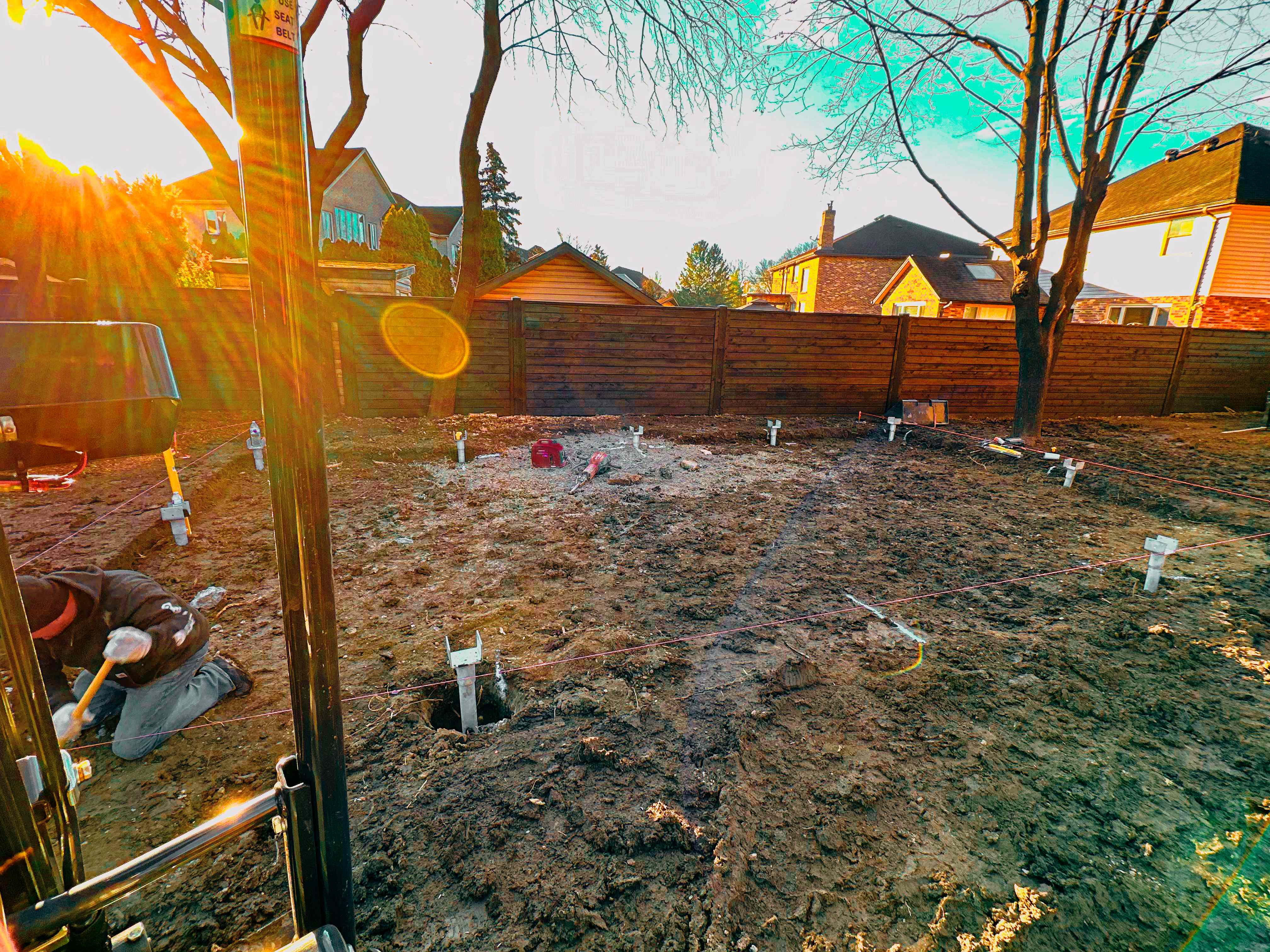 Professional helical piles installation at residential construction site in Windsor Ontario showing foundation repair work
